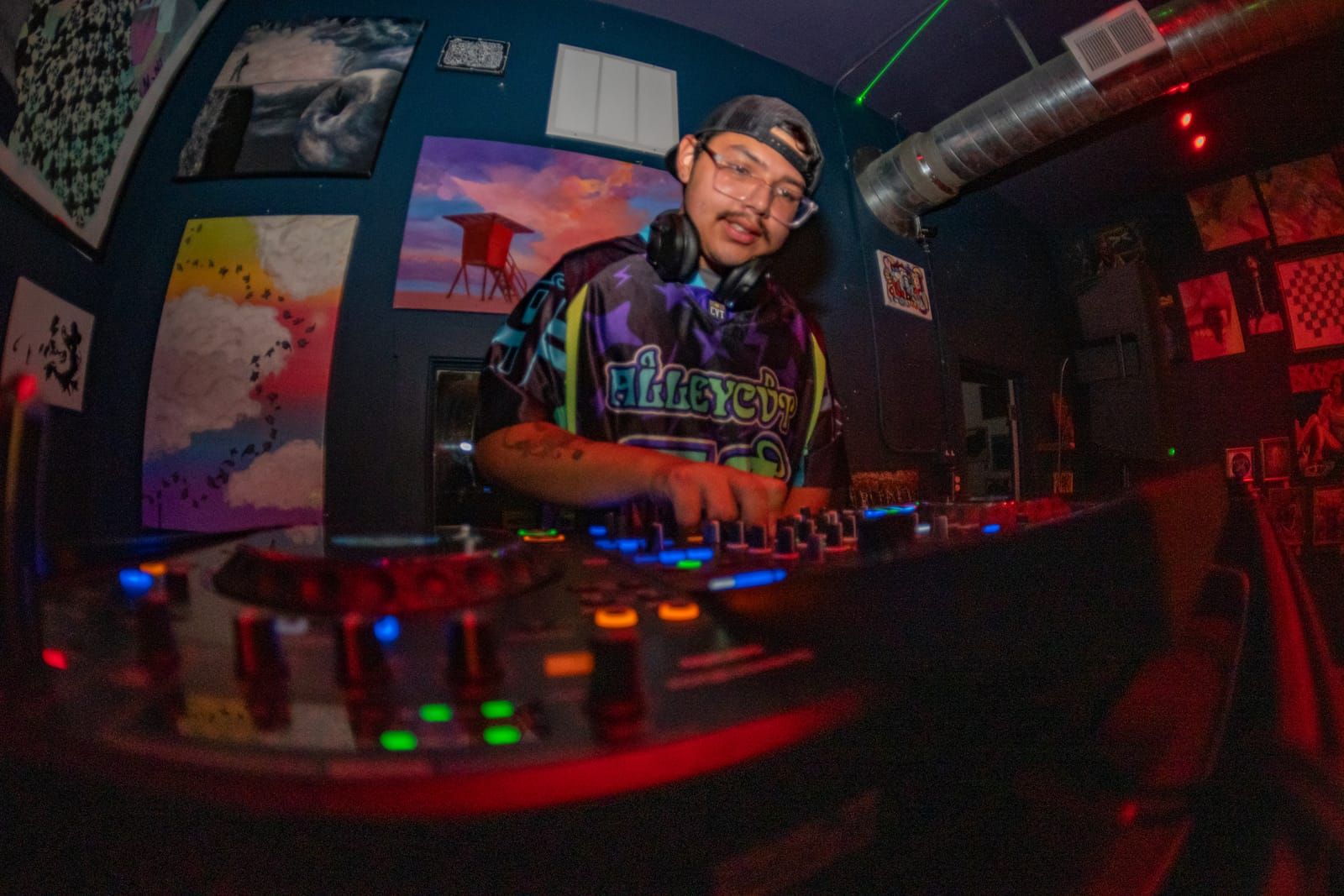 Fisheye shot of Dill the Menace working the decks under red light