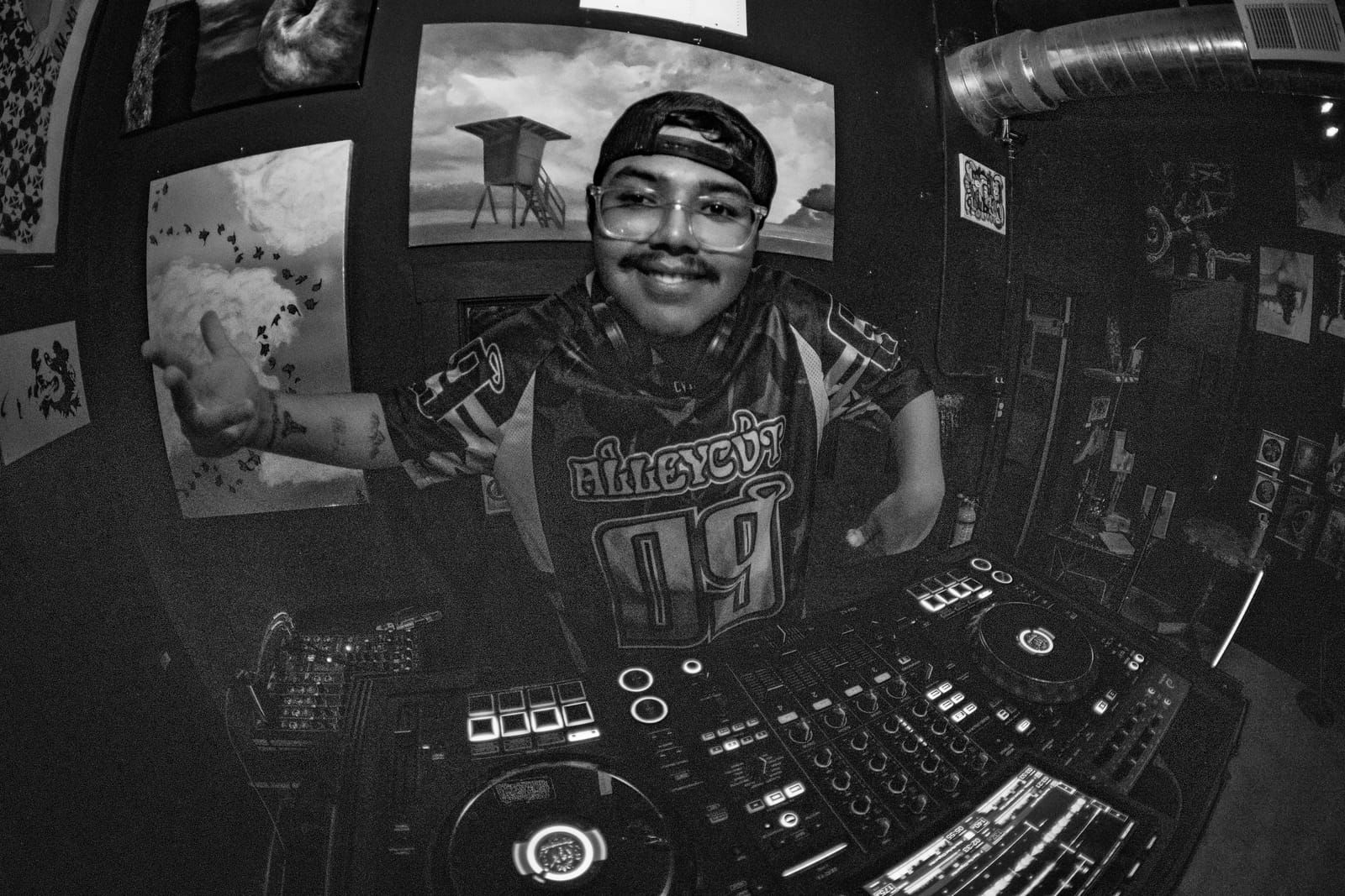 Black and white shot of Dill the Menace working the mixer at The Logan Gallery