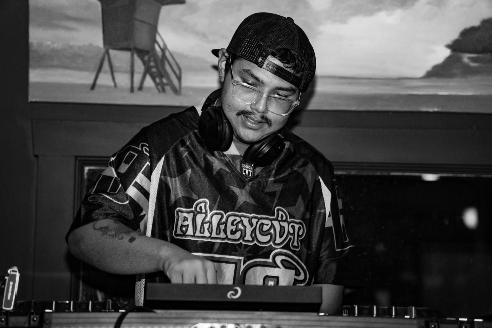 Black and white shot of Dill the Menace cueing up the next track