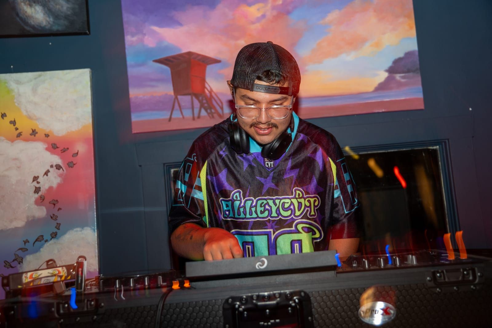Dill the Menace mixing calmly beneath the gallery's painted sunset
